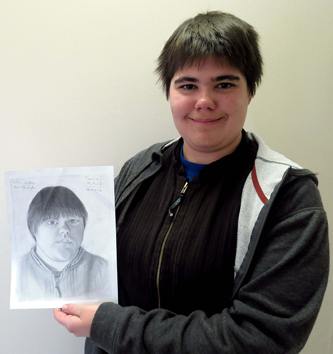 Tanice McMinis poses with her self-portrait.