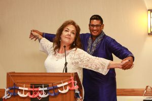 Host Lori Gibbs and Shaneef briefly reenact a scene from Titanic.