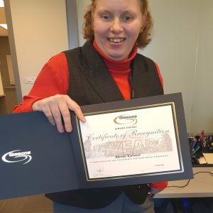 Central client Rhonda Kottusch shows off the certificate she received from Gibson Energy.